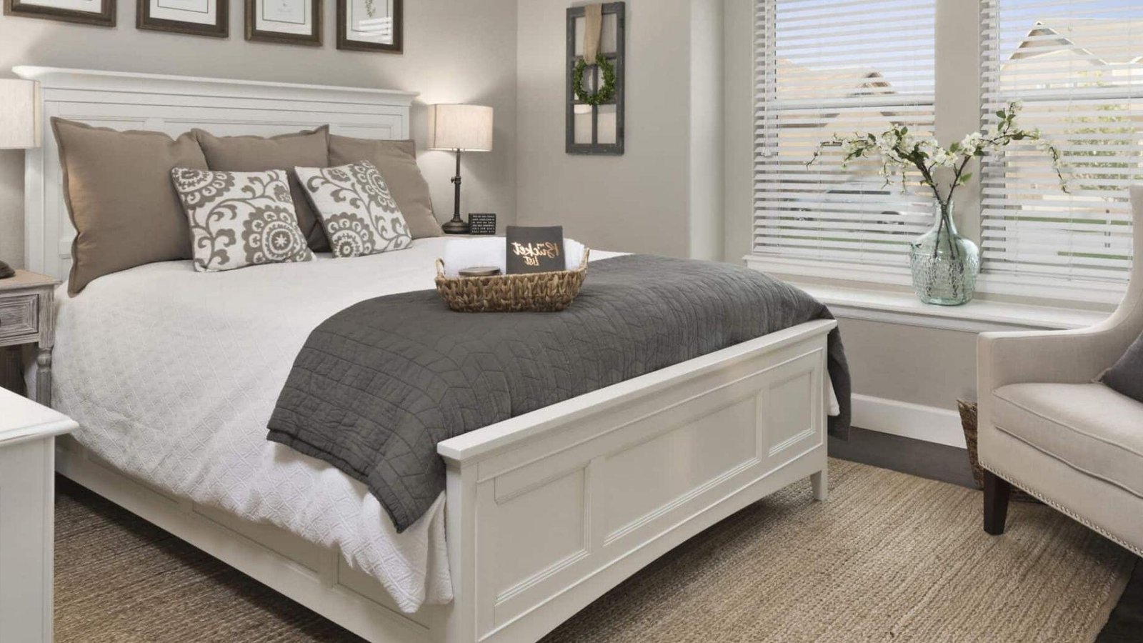 Cozy bedroom featuring a bed, dresser, and large window providing natural light.