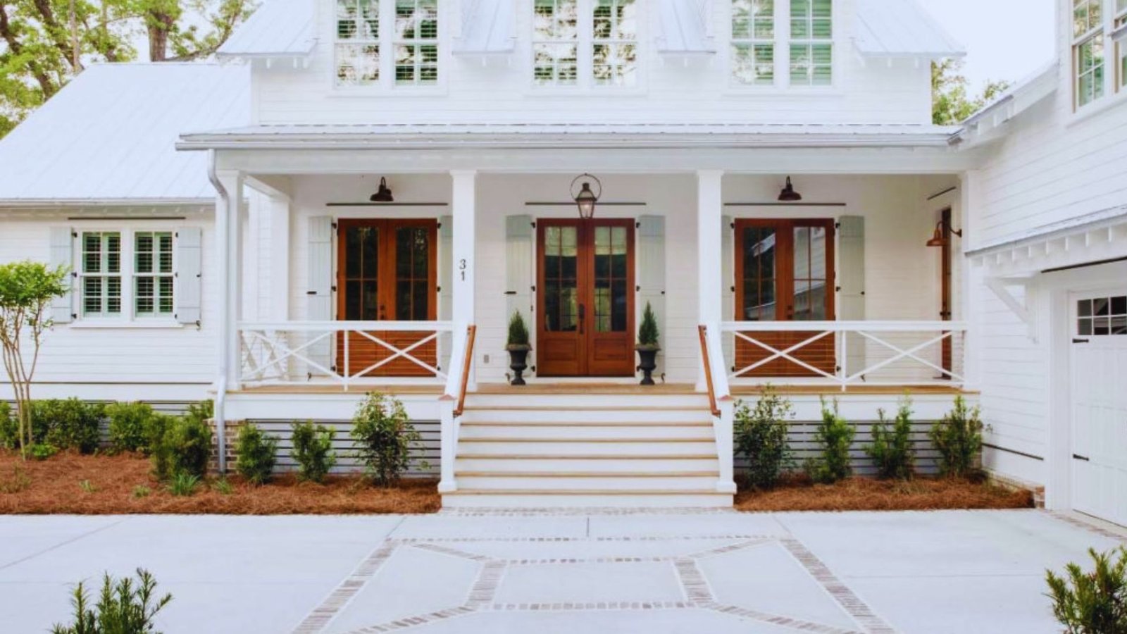 Stately white house with a welcoming front porch and a prominent central entrance.