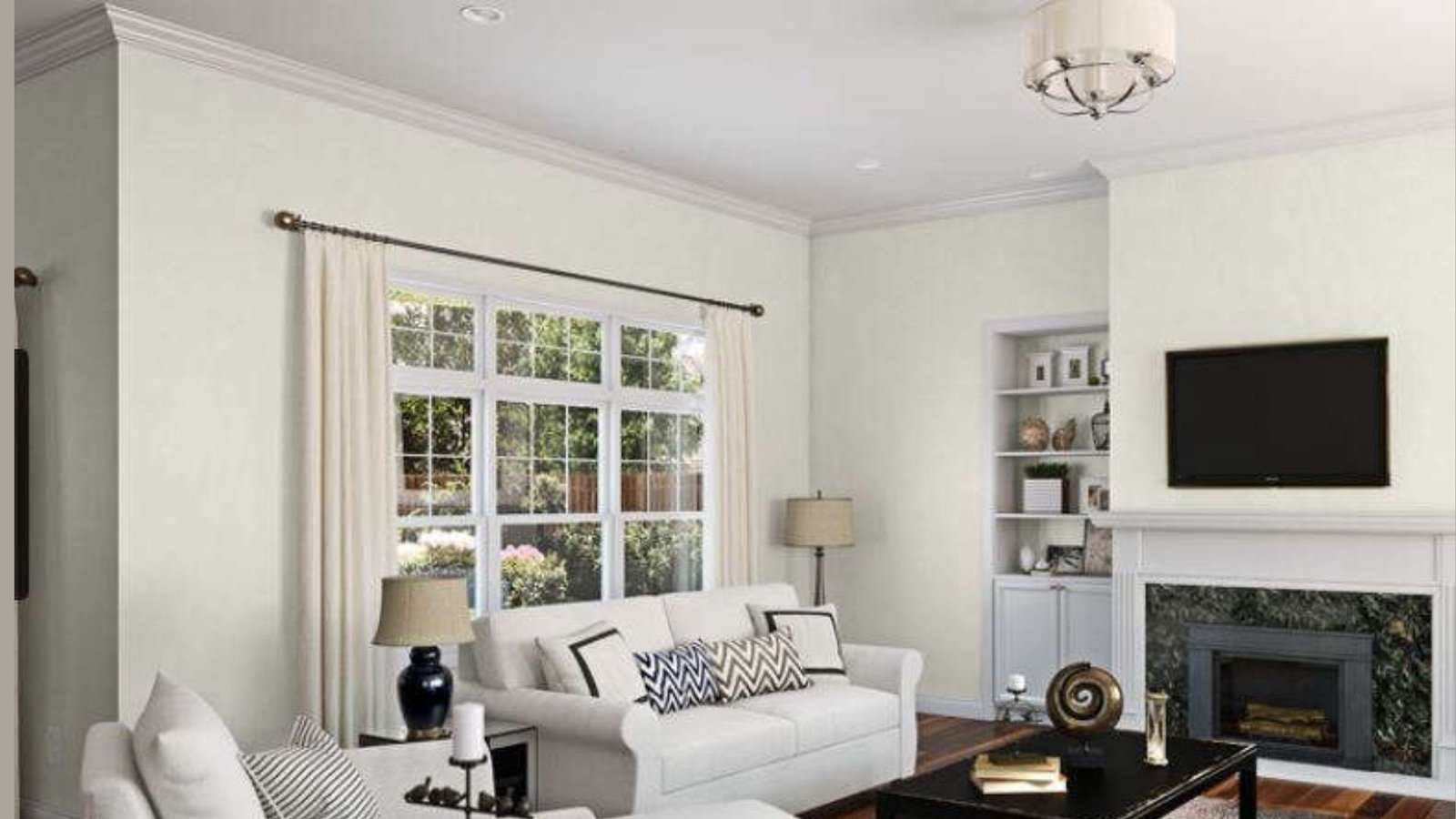 Spacious living room with white couch, armchair, and fireplace.