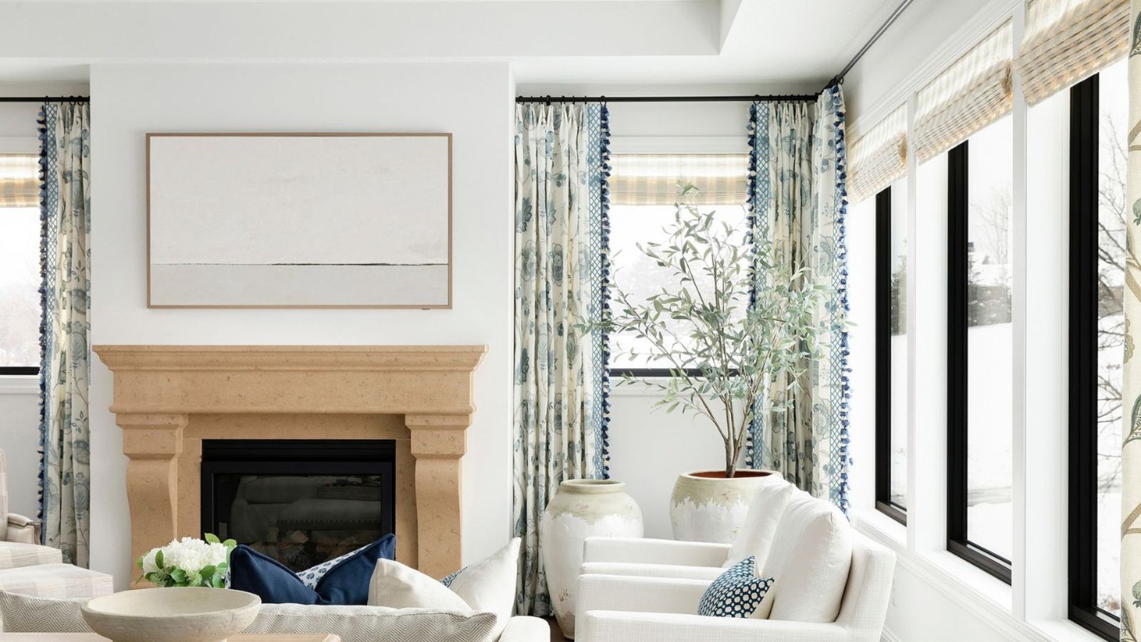Minimalist living room decor featuring white seating and blue decorative elements.